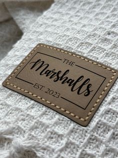 a close up of a label on a white knitted material that says the marshalls est 2052