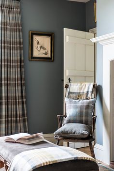 a chair and ottoman in a room with blue walls