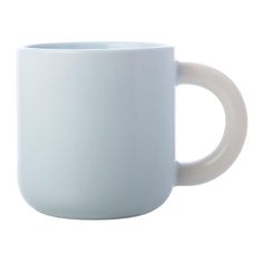 a white coffee mug sitting on top of a table