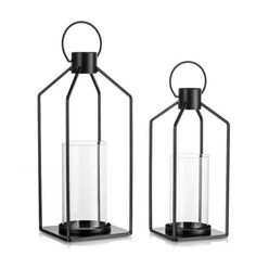 two black metal lanterns with clear glass inside