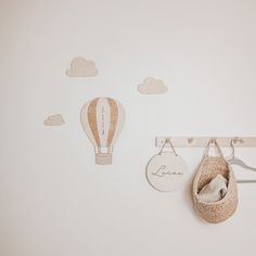 a baby's crib with a hot air balloon hanging on the wall next to it