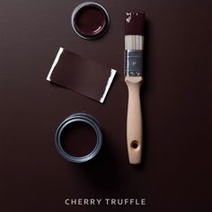 a brown table with paint, brush and two different colors of paint on it that says cherry truffle