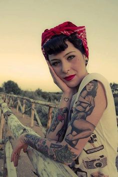 a woman with tattoos on her arms and arm