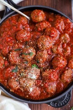 a skillet filled with meatballs and marinara sauce