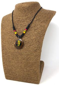 "Rasta Necklace. Handmade Rastafarian Design. Unisex. Handmade with black cord, wooden beads and coconut shell wood pendant with rasta man design. Stylish Minimalist Design. Rastafarian Necklace. Unisex Design. Necklaces is 16\" inches Around the neck. And the wooden pendant is 1\" Inch long. Comfort Fit Necklace. FAST & FREE SHIPPING! First Class Mail Visit my Etsy Shop to see more Designs! Handmade Rasta Wooden Earrings, Rasta Bracelets and Necklaces. Click here to see more designs: https: Rasta Necklace, Rasta Man, Hawaiian Necklace, Puka Shell Necklace, Man Design, Puka Shell, Wooden Pendant, Wood Pendant, Coconut Shell