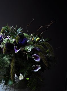 a vase filled with purple and white flowers