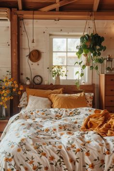 a bedroom with white walls and wooden floors has sunflowers on the bedspread