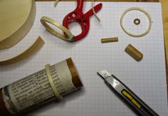 some crafting supplies are laid out on top of a piece of paper with scissors and tape