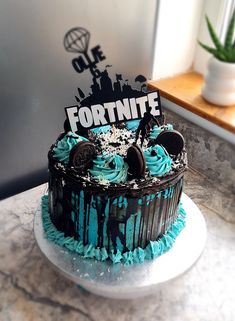 a cake with blue frosting and oreo cookies on top that says fortnite