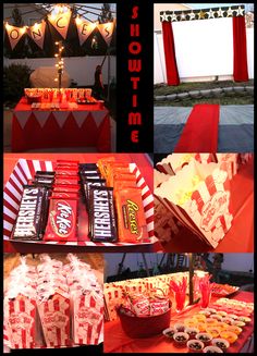 an assortment of candy and snacks displayed on a red table cloth with lights strung from above