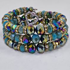 the multi - colored bracelet is adorned with crystal beads