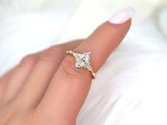 a woman's hand with a diamond ring on it