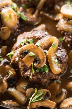 mushroom steaks with mushrooms and gravy in a skillet