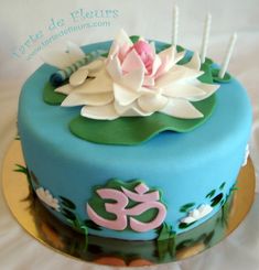 there is a blue cake with white flowers on it