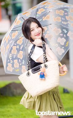 a woman is holding an umbrella and purse