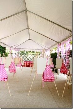 the inside of a tent with pink and white polka dots on it, hanging from strings