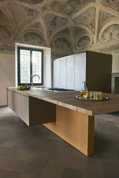 a kitchen with an island counter and two glasses on it