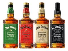 three bottles of jack daniels are lined up against a white background and one is empty