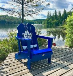 a blue chair sitting on top of a wooden dock