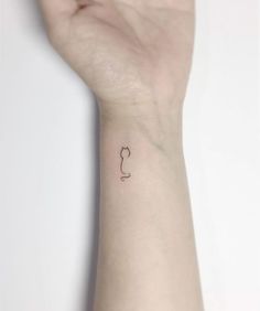 a person's arm with a small tattoo on the left side of their wrist