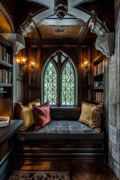 a room that has some bookshelves and a couch in it with pillows on the floor