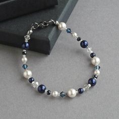 This navy and white bracelet is created using glass pearls, sparkling crystals and glass beads. The crystals really sparkle in the light and compliment the lustre of the pearls. Each dark blue pearl and crystal bracelet measures 18cm/7.25 inches in length and is finished with a gunmetal-plated lobster clasp. I have added a 1 inch extension chain to allow you to adjust your single strand bracelet to fit.  Your midnight blue jewellery will arrive carefully gift wrapped in the pretty, black box pic Necklaces With Beads, Groom Jewellery, Navy Blue Themed Wedding, Bride Decor, Chunky Stone Necklace, Dark Blue Wedding, Blue Mother Of The Bride, Chunky Pearl Necklace, Blue Wedding Jewelry