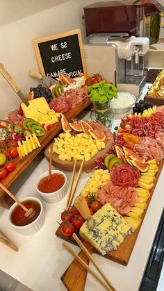 an assortment of cheeses and meats on display at a buffet