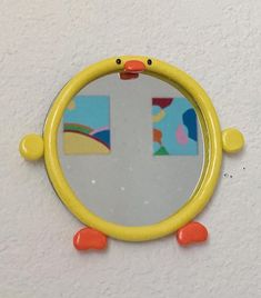 a yellow mirror hanging on the wall