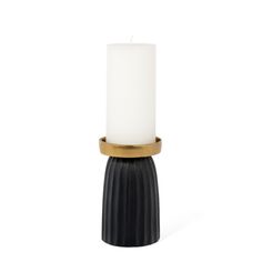 a black and gold candle holder with a white candle in the center on a white background