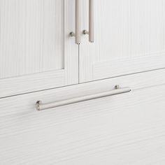 a white cabinet with two doors and some handles on the door handle is shown in this image