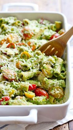 a casserole dish with broccoli, tomatoes and other veggies