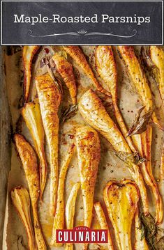 baked chicken wings on a baking sheet with herbs and seasonings in the bottom right corner