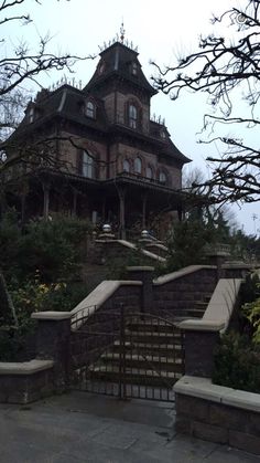 an old house with stairs leading up to it