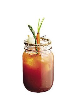 there is a drink in a mason jar with carrots sticking out of the top