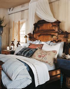 a large bed sitting in a bedroom next to a wooden headboard and foot board