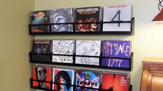 a wall mounted cd rack with various records on it