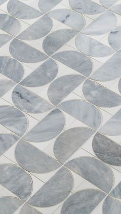 a white and grey tiled floor with circles on it