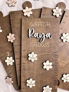 five wooden growth rulers with flowers on them and the words watch paga grows written on them