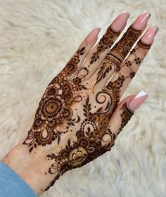 a woman's hand with henna on it