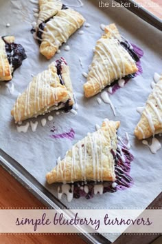 blueberry turnovers on a baking sheet with icing