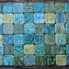 some green and blue tiles with leaves on them