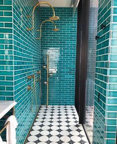 a bathroom with blue and white tiles on the walls