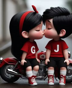 two dolls are kissing on a motorcycle