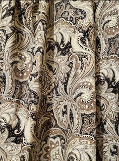 a close up view of a paisley print curtain