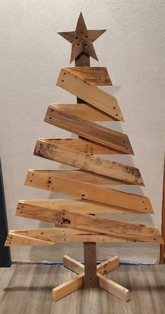 a wooden christmas tree made out of wood planks