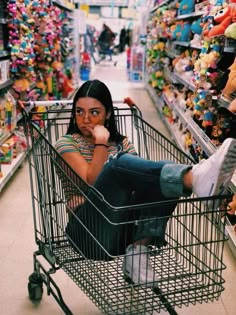 a woman is sitting in a shopping cart