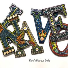 the letters are made out of stained glass and have different designs on each letter's sides