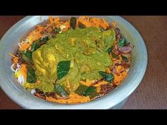 a bowl filled with food on top of a wooden table