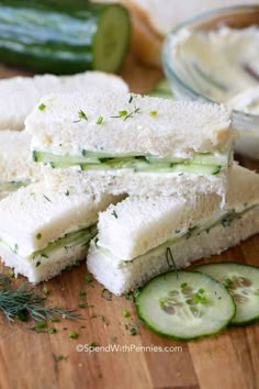 cucumber sandwiches cut in half on a cutting board