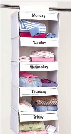 an organized closet with clothes hanging from the ceiling and labeled days of the week on it